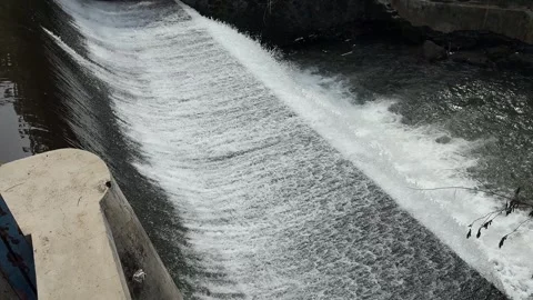 Side View of Beautiful River Flows from Three Level Dam in the City Stock Footage 267719989