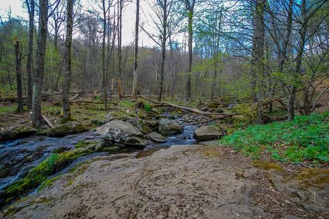 Side view of a beautiful small waterfall and pool in the mountains Stock Photos