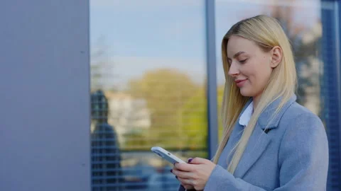 Side View of the Beautiful Woman Multitasking, Using a Modern Cellphone While Stock Footage 256142009