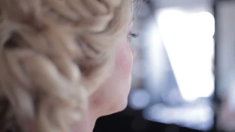 A side view of beautiful women getting a professional make up Stockbeeldmateriaal 71242396