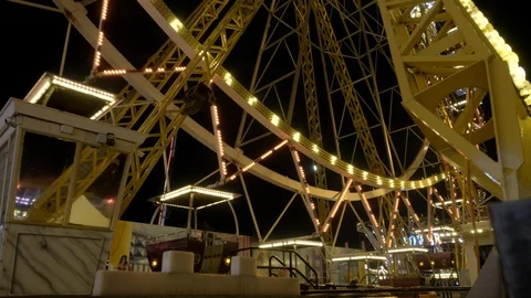 Side view of beautifully lit ferris wheel at night in Odessa Stock Footage 99337803