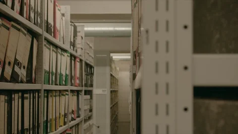 Side view between the rows of shelves of an archive. Stock-Footage 95442525
