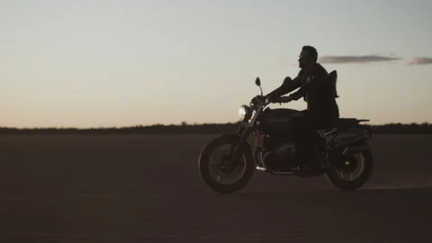 Side view of A Biker on a ride in the desert wearing all black Stock Footage 264134633