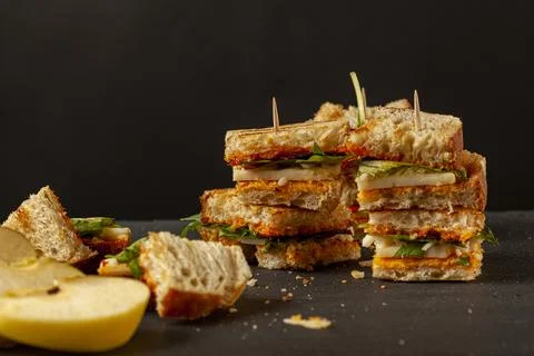 Side view of Bite size cheese sandwich in toasted bread on toothpricks Stock Photos