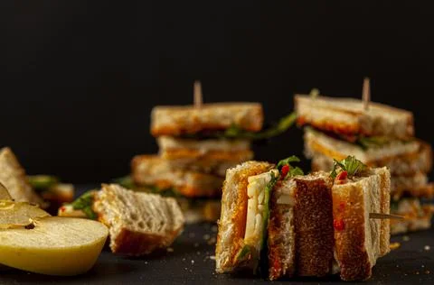 Side view of Bite size cheese sandwich in toasted bread on toothpricks Stock Photos