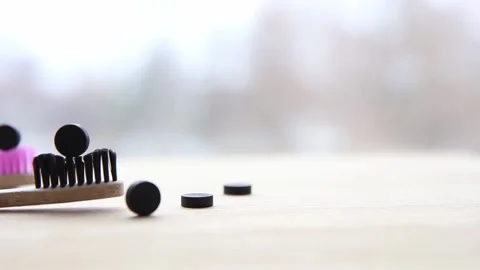 Side view of black activated charcoal toothpaste tablets. Stock Footage 149042953