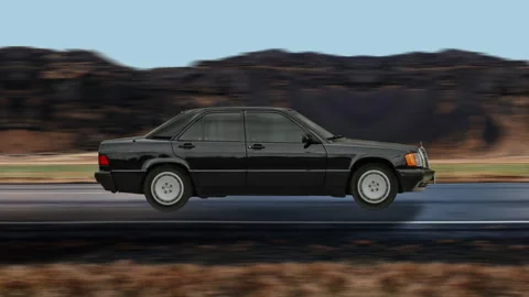 Side view of a Black Car driving on highway at high speed, mountain background. 스톡 동영상 332438755