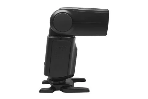 A side view of a black external camera flash speedlight mounted on a hot sh.. Stock-Fotos