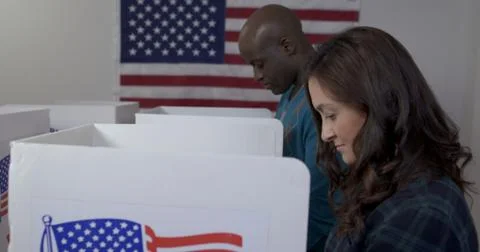 Side view black man and white woman voting Stock Photos