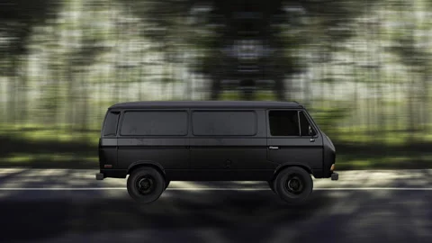 Side view of a Black Van driving on highway at high speed, forest background. Stock Footage 332315276