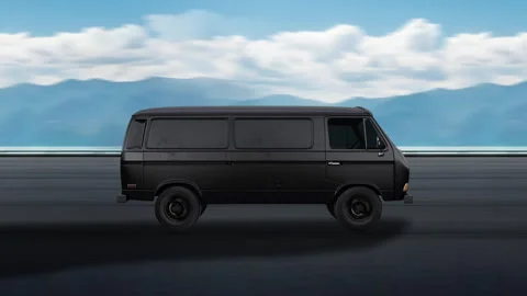 Side view of a Black Van driving on highway at high speed, sky and mountains. Video stock 332315316