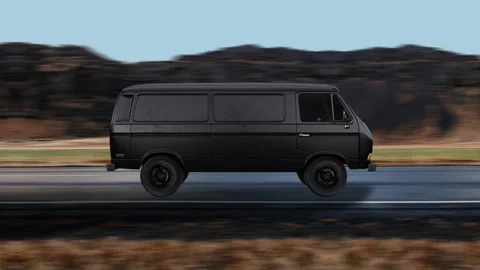 Side view of a Black Van driving on highway at high speed, mountain background. Stock-Footage 332315328