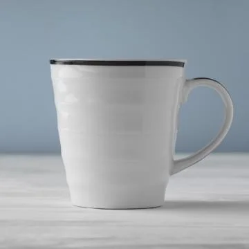 Side view of blank white cup on white table and blue background Stock Photos
