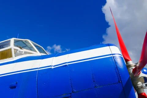 Side view of blue airplane with red propeller Stock Photos