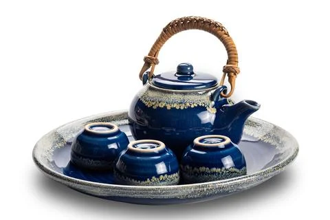 Side view of blue ceramic tea set with cups in a tray. Stock Photos