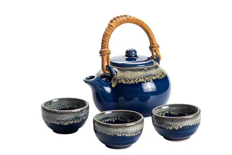 Side view of blue ceramic tea set with cups. Stock Photos