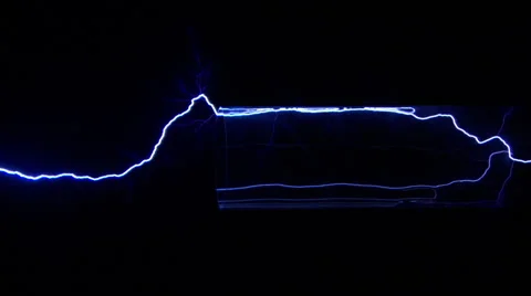 Side view of blue electric arcs shooting through and beyond clear tube Stock Footage 59468474