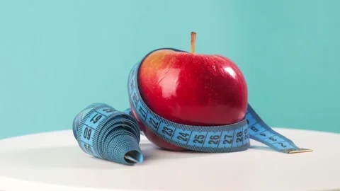 A side view of Blue Measuring Tape and Fresh Fruits on a Whiteboard. Proper Stock Footage 202744641