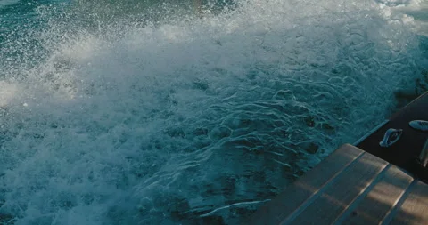 Side view blue waves behind a passenger boat view from the side of a yacht boat Stock Footage 229641898