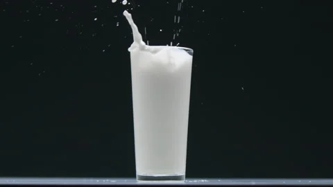 Side view blueberry falling into the glass with milk and make a splash Stock Footage 131153804