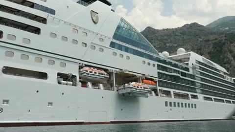 Side view of a boat moving forward on the sea bay. Seascape with big cruise ship Stock Footage 104598608