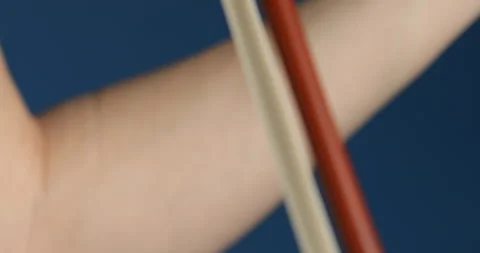 Side view of bowing the bow of a classical violin Stock Footage 253445993