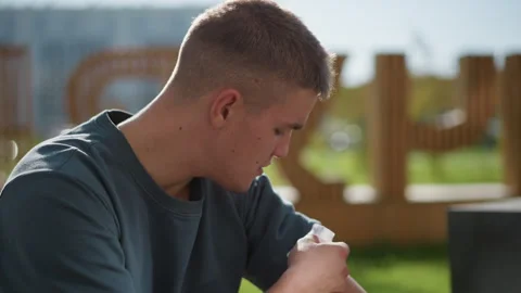 Side view of boy enjoying outdoor sunlight while applying nicotine patch Stock Footage 307055937