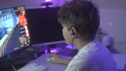 Side view, boy playing computer game with shooting games Stock Footage 305646496