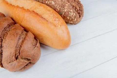 Side view of breads as vietnamese and black seeded baguette and black bread o Stock Photos