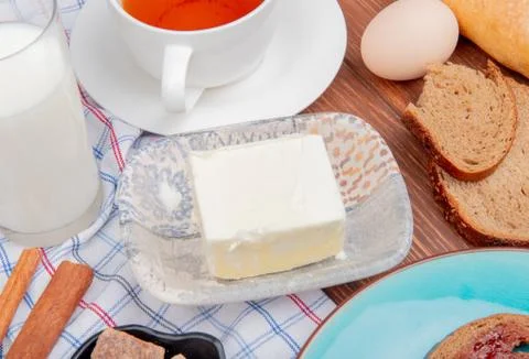 Side view of breakfast set with butter rye bread slices smeared with jam in p Stock Photos