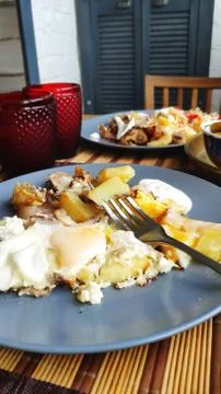 Side view breakfast for two, baked fish and potatoes with pickles, English br Stock Photos