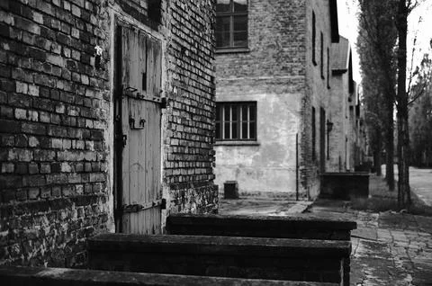 Side view of brick barracks and wooden doors in Auschwitz camp Stock Photos