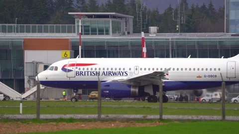 Side view of British Airways passenger aircraft taxiing on the taxiway Stock Footage 240645301