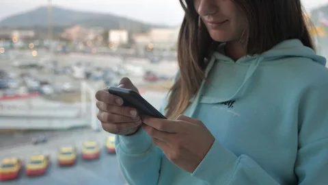 Side view brunette woman using smartphone near airport window. Girl is texting Video stock 124187287