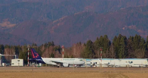 Side view of Brussels Airlines passenger airplane taxiing on the taxiway Stock Footage 222156407