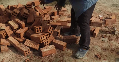 Side view Builders are building a brick wall. Construction work at a Stock Footage 306229523