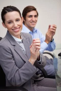 Side view of business team clapping while sitting at desk Stock Photos