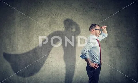Side view of a businessman imagining to be a super hero looking aspired. Stock Photos