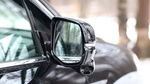 The side-view camera is installed in the side mirror of a black car. 360 degree Stock Footage 165778188