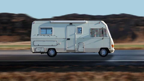 Side view of a Camper driving on highway at high speed, mountain background. Video stock 332448317
