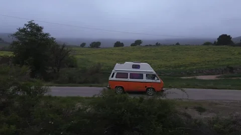 Side view of a camper van on a road between meadows. Stock Footage 275503470