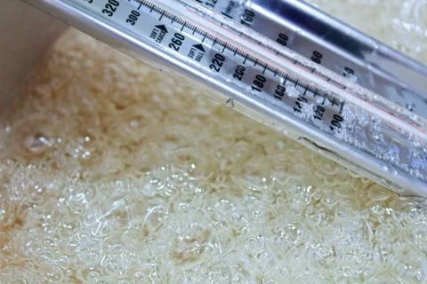 Side view of a candy thermometer as liquid boils Stock Photos