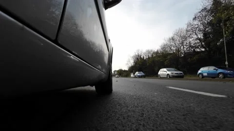 Side view of a car driving on a British road 動画素材 240022560