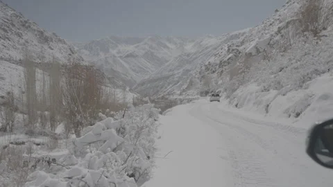 Side View of Car Driving Through Scenic Ladakh Landscape - 28th Feb 2025 Stock Footage 312203009