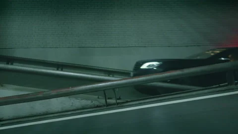 Side view of a car moving up at underground parking, industrial background Stock Footage 234734172