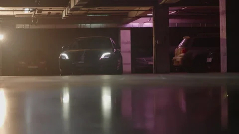 Side view of a car moving up at underground parking, industrial background Stock Footage 243260309