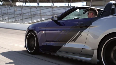 Side view of car speeding on racetrack Stock Footage 191312386