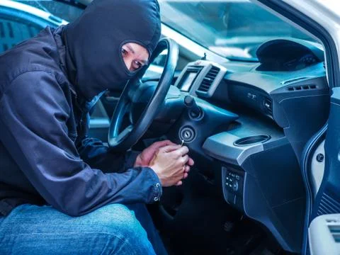 Side view of car thief in action Stock Photos