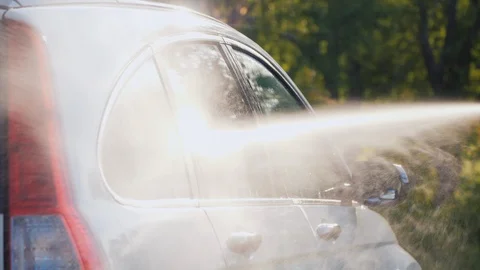 Side view of a car washed with a high pressure washer Stock Footage 115990555