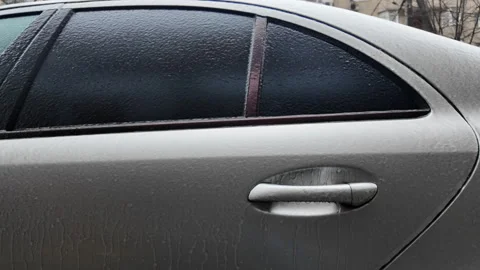 Side view of a car window covered in frost and ice, creating a textured frozen 스톡 동영상 329402867